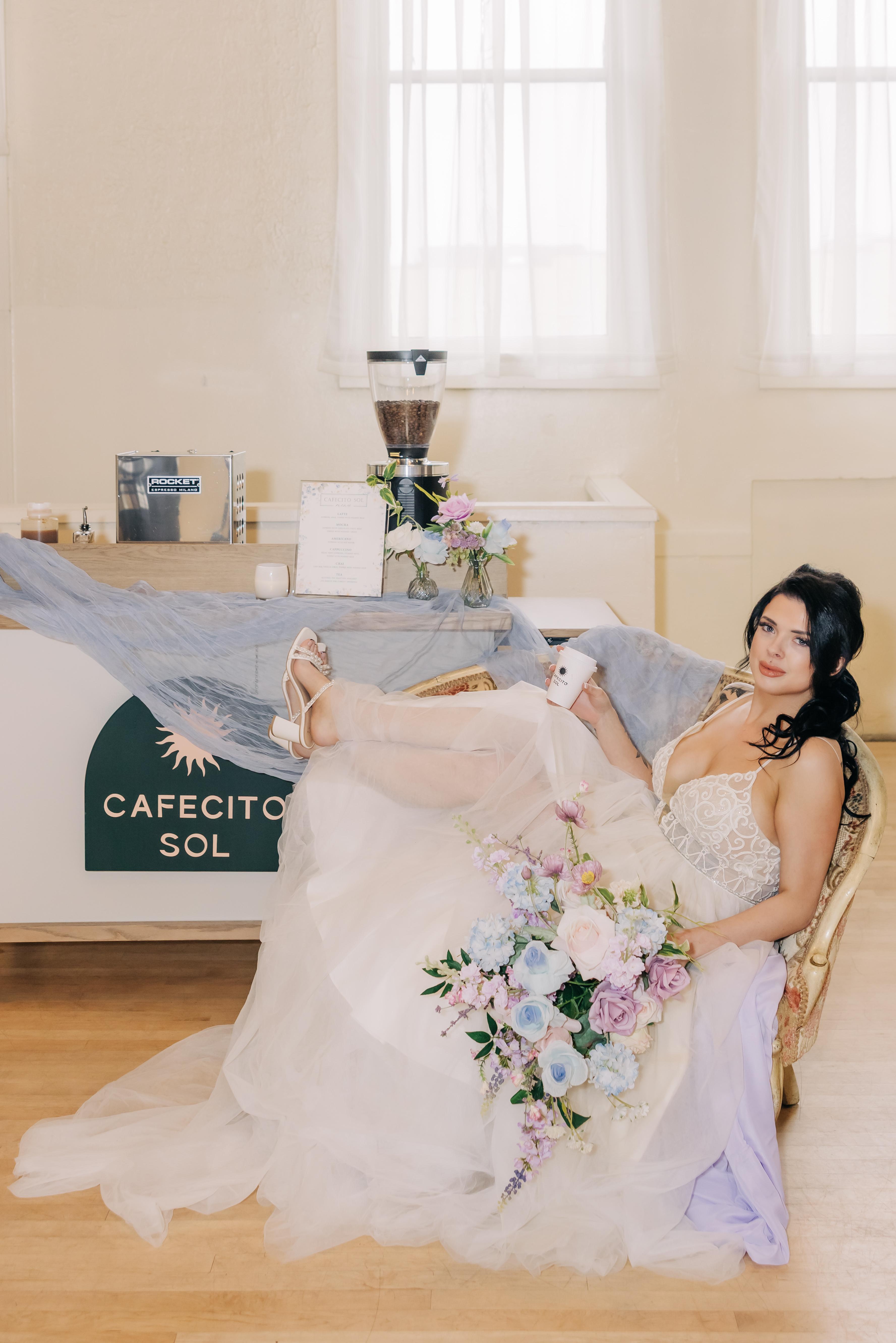 The Cafecito Sol coffee cart styled with florals at a wedding reception